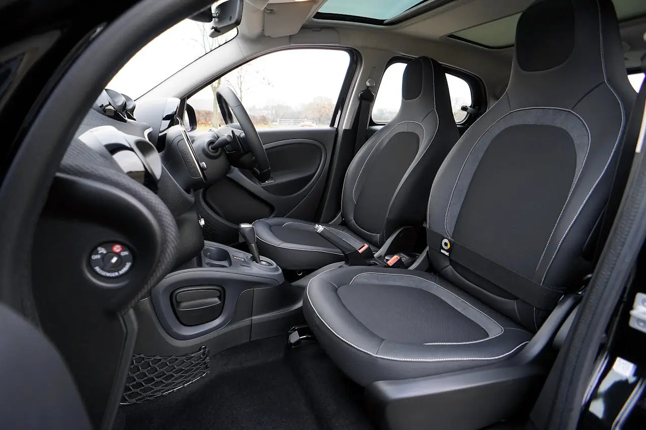 An open vehicle with black leather car seats.