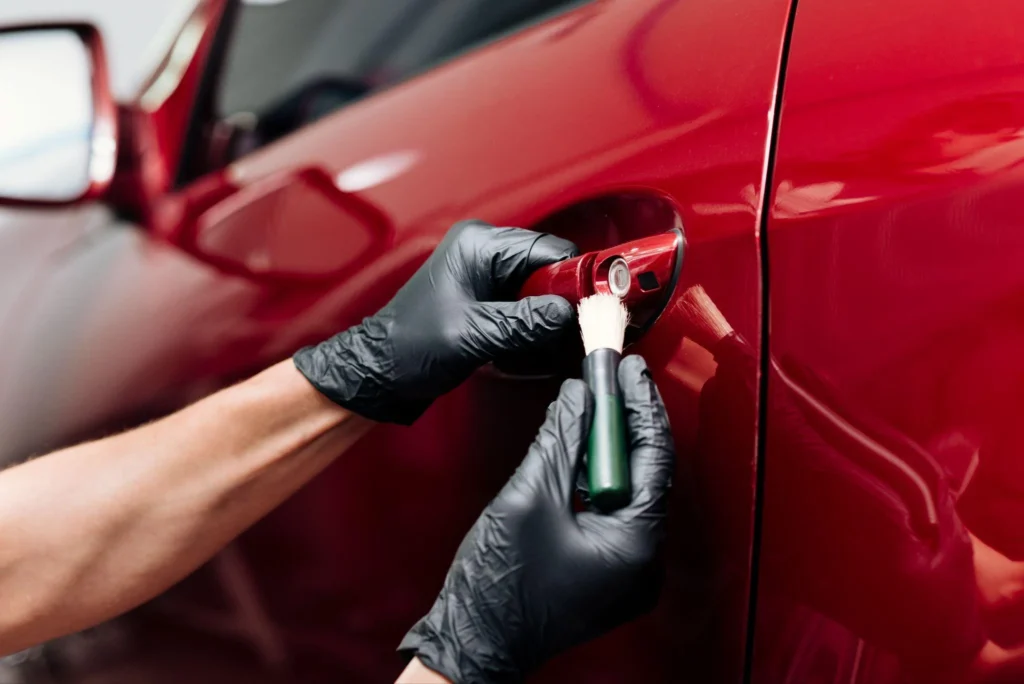 Close up of person cleaning car exterior
