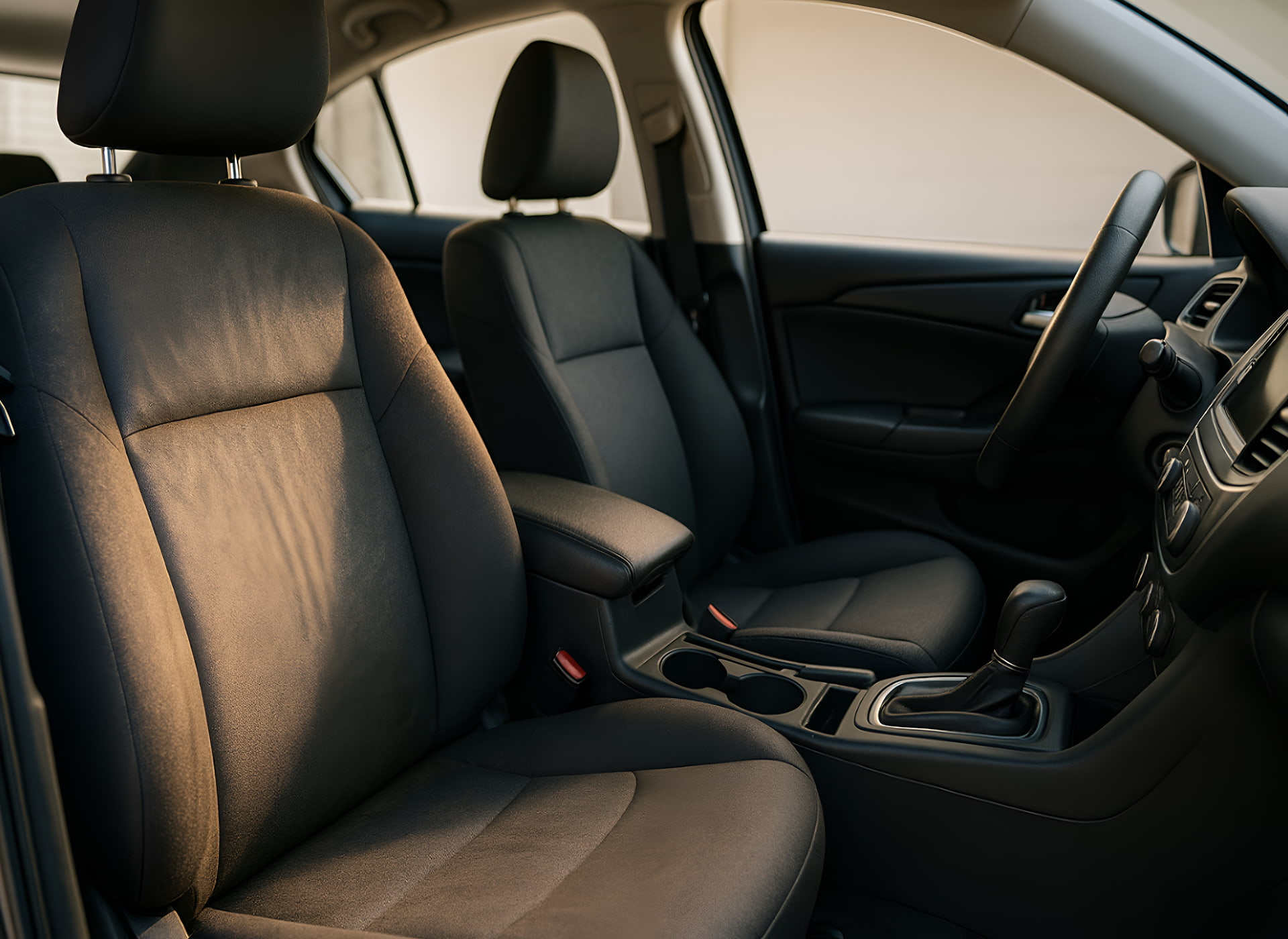 Clean and well-maintained black fabric car seats inside a modern vehicle interior