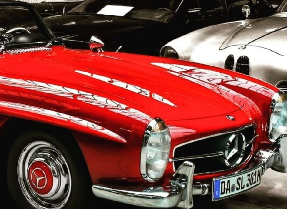 Classic cars in a collection garage, a red convertible in the foreground